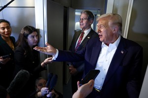 U.S. President Donald Trump speaks to reporters as U.S. Treasury Secretary Scott Bessent stands next to him aboard Air Force One en route to Tokyo, Japan, for the second stop on his Asia tour, October 27, 2025. REUTERS/Evelyn Hockstein