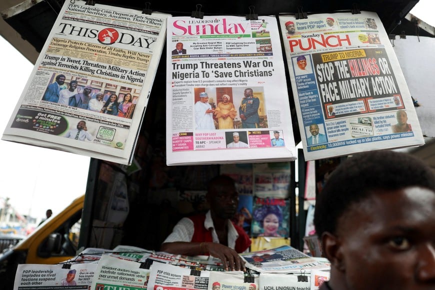 Newspapers with articles reporting U.S. President Donald Trump's message to Nigeria over the treatment of Christians hang at a newspaper stand in Ojuelegba, Lagos, Nigeria November 2, 2025. REUTERS/Sodiq Adelakun