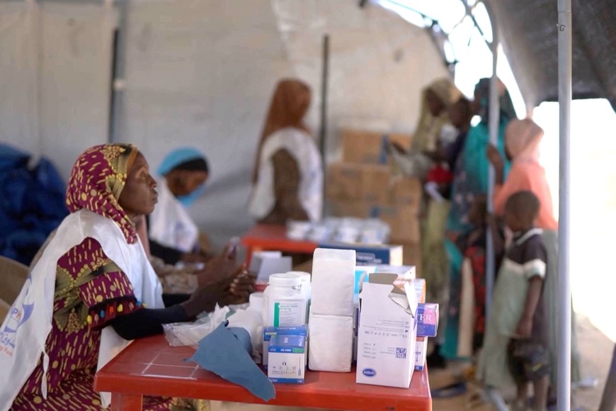 A medic waits in a makeshift clinic as displaced Sudanese gather after fleeing Al-Fashir city in Darfur, in Tawila, Sudan, October 29, 2025, in this still image taken from a Reuters' video. REUTERS/Mohamed Jamal