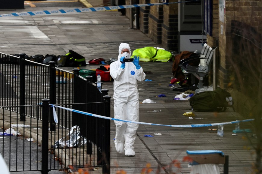 A forensic officer works at the scene at Huntingdon Station following a series of stabbings on a train, near Cambridge, Britain, November 2, 2025. REUTERS/Jack Taylor