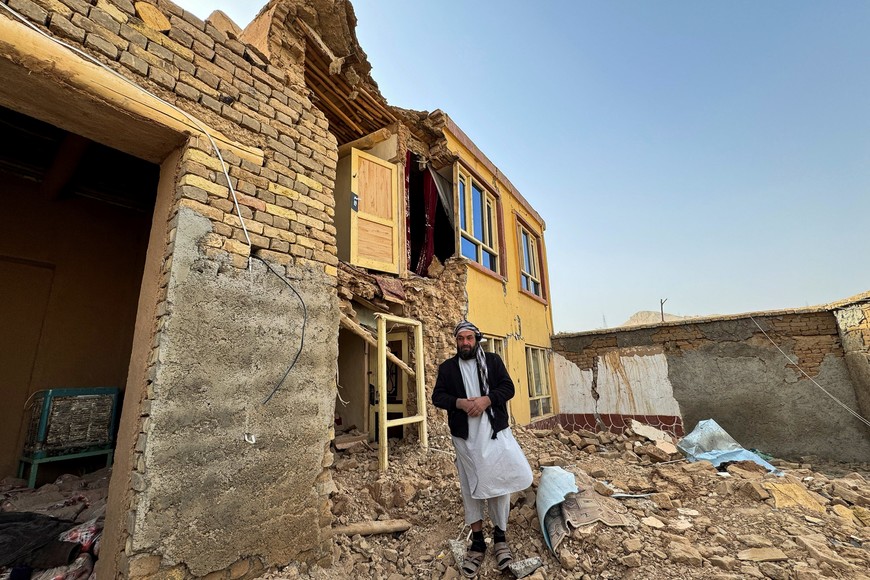 A man stands next to a damaged building in the aftermath of an earthquake in Samangan province, Afghanistan November 3, 2025. REUTERS/Stringer