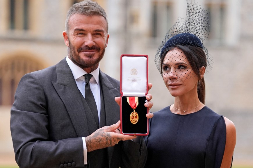 Sir David Beckham, stands with his wife Lady Victoria, after he was made a Knight Bachelor at an investiture ceremony at Windsor Castle, Berkshire. November 4, 2025. Andrew Matthews/Pool via REUTERS