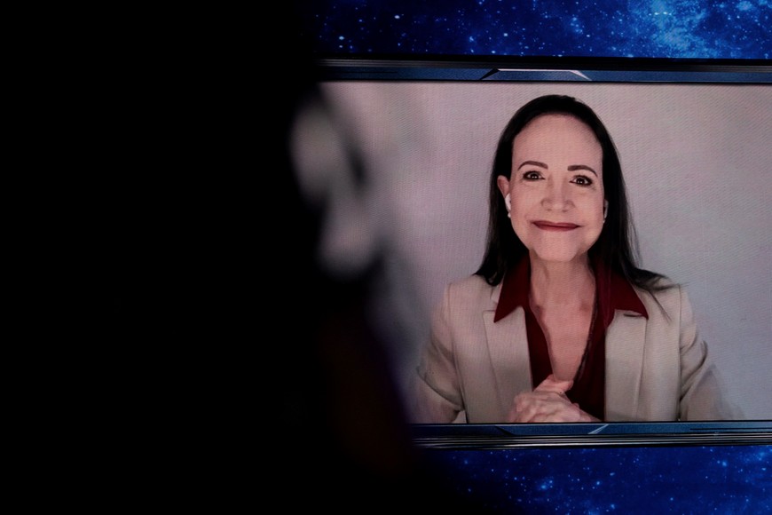 Venezuela's opposition leader and winner of the 2025 Nobel Peace Prize Maria Corina Machado attends the America Business Forum via video conference at Kaseya Center in Miami, Florida, U.S. November 5, 2025. REUTERS/Marco Bello