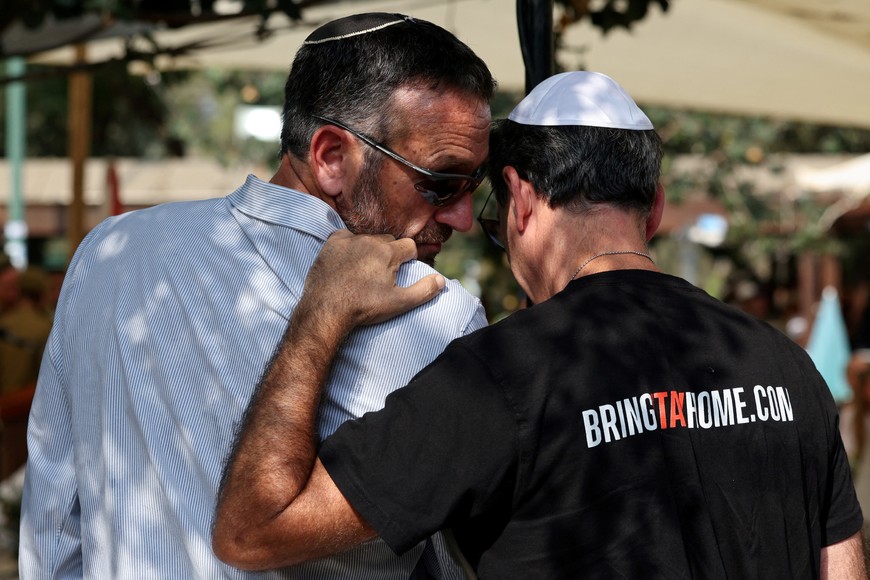 Former Chief of the General Staff of the Israeli military Herzi Halevi and Ruby Chen, father of deceased Israeli hostage Itay Chen, who was killed during the deadly October 7, 2023, attack on Israel by Hamas and whose body was taken to Gaza, attend the funeral of retrieved hostage, Israeli soldier Colonel Asaf Hamami, a brigade commander who Israeli authorities say was killed defending Kibbutz Nirim during the Hamas attack and whose body was also taken to Gaza, at the Kiryat Shaul cemetery in Tel Aviv, Israel, November 4, 2025. REUTERS/Nir Elias