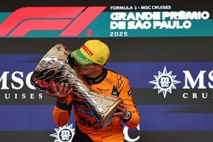 Formula One F1 - Sao Paulo Grand Prix - Autodromo Jose Carlos Pace, Sao Paulo, Brazil - November 9, 2025
McLaren's Lando Norris celebrates on the podium with a trophy after winning the Sao Paulo Grand Prix REUTERS/Amanda Perobelli