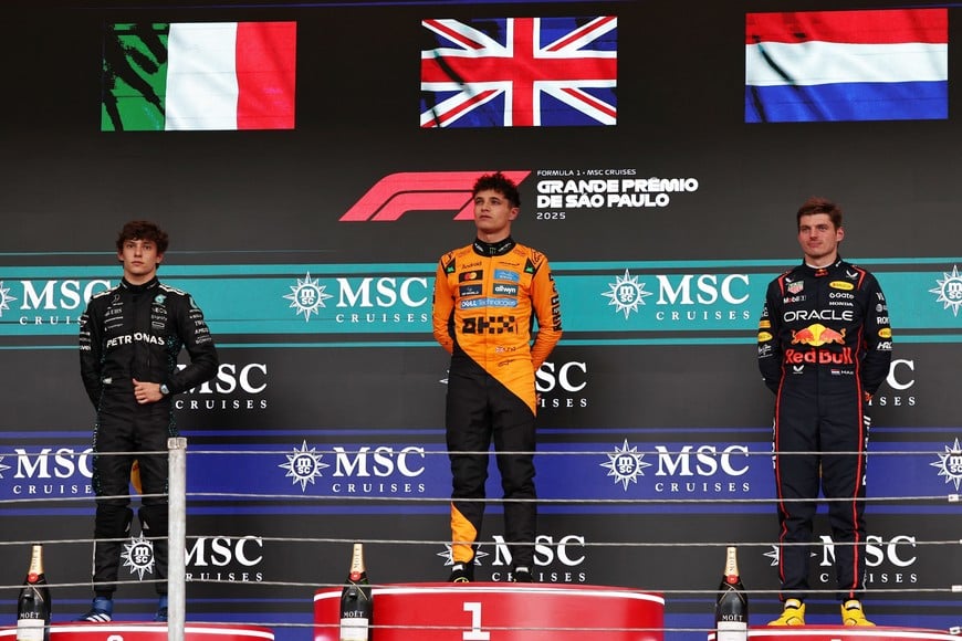 Formula One F1 - Sao Paulo Grand Prix - Autodromo Jose Carlos Pace, Sao Paulo, Brazil - November 9, 2025
McLaren's Lando Norris celebrates on the podium after winning the Sao Paulo Grand Prix with second placed Mercedes' Andrea Kimi Antonelli and third placed Red Bull's Max Verstappen REUTERS/Amanda Perobelli