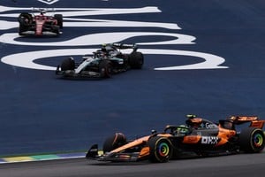 Formula One F1 - Sao Paulo Grand Prix - Autodromo Jose Carlos Pace, Sao Paulo, Brazil - November 9, 2025
McLaren's Lando Norris and Mercedes' Andrea Kimi Antonelli in action as Ferrari's Charles Leclerc after losing a wheel and later retires from the race REUTERS/Amanda Perobelli