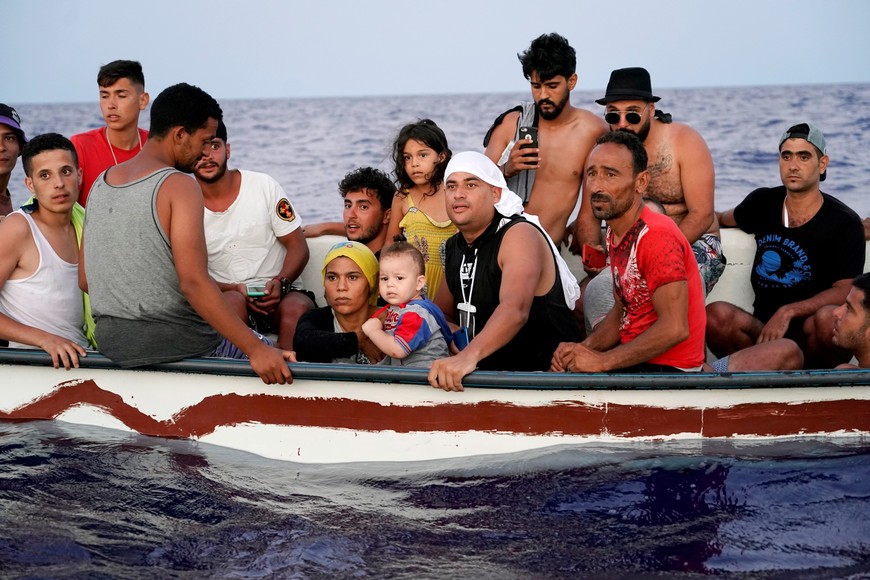 Some eighteen migrants navigate on a wooden boat to the Italian island of Lampedusa, in the Mediterranean Sea, August 28, 2021. REUTERS/Juan Medina