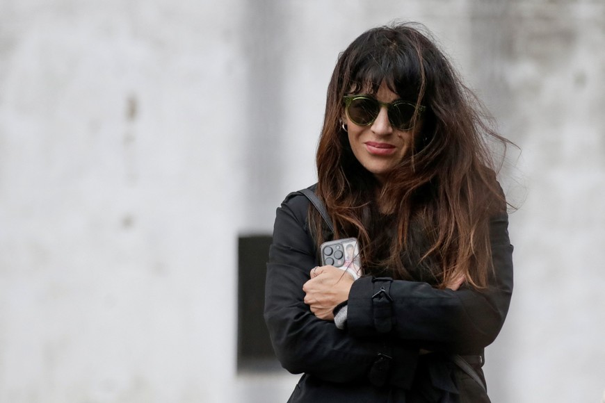 Gianinna Maradona, daughter of late Argentine soccer legend Diego Maradona protects herself from the wind outside the San Isidro court during a recess in the continuation of the trial of her father's death, as the Argentine court is expected to rule over an investigation on Judge Julieta Makintach participating for allegedly taking part in a secretly filmed documentary of the trial, in San Isidro, on the outskirts of Buenos Aires, Argentina, May 27, 2025. REUTERS/Francisco Loureiro