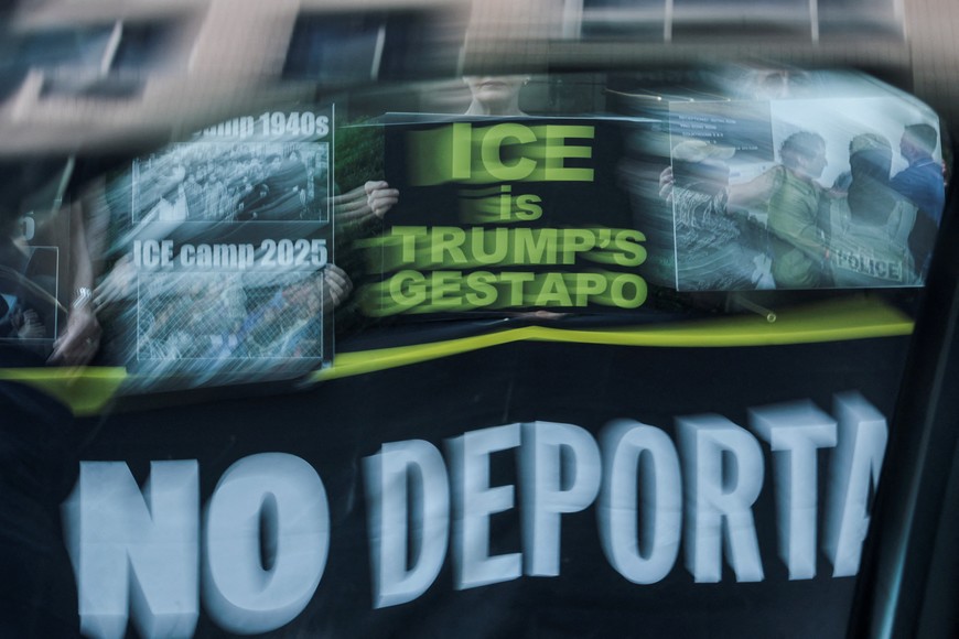 People hold signs during a silent vigil protesting U.S. Immigration and Customs Enforcement (ICE) outside the U.S. immigration court in Manhattan, New York City, July 24, 2025. REUTERS/Jeenah Moon