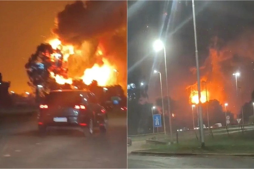 Vecinos evacuados observan cómo avanzan las llamas en los galpones industriales.