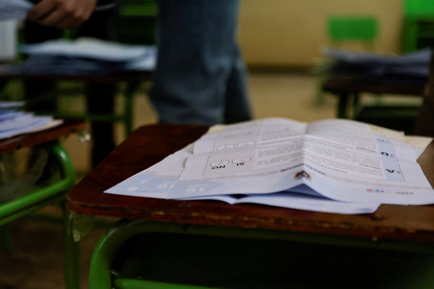 A ballot sits on a table as people participate in the vote counting process during a referendum to decide whether to allow the return of foreign military bases, which Ecuador’s President Daniel Noboa says are central to fighting organized crime, and whether they back convening an assembly to rewrite the constitution, in Quito, Ecuador November 16, 2025. REUTERS/Karen Toro