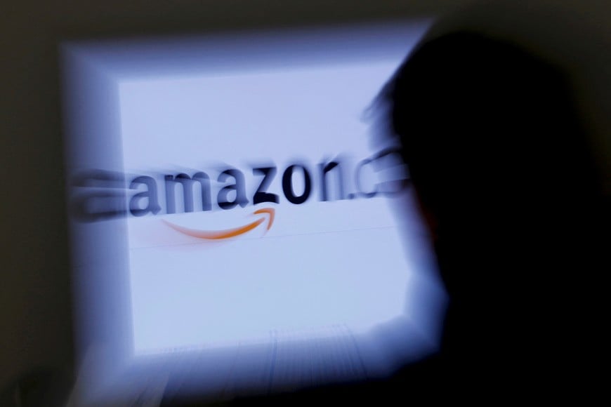 FILE PHOTO: A zoomed illustration image of a man looking at a computer monitor showing the logo of Amazon is seen in Vienna November 26, 2012. To match Special Report TAX-AMAZON REUTERS/Leonhard Foeger (AUSTRIA - Tags: POLITICS BUSINESS)/File Photo