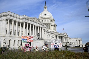 Protesters hold signs before a press conference on the Epstein Files Transparency Act, ahead of a House vote on the release of files related to the late convicted sex offender Jeffrey Epstein, on Capitol Hill in Washington, D.C., U.S., November 18, 2025. REUTERS/Annabelle Gordon