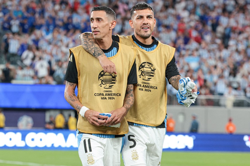 FILE PHOTO: Jun 25, 2024; East Rutherford, NJ, USA; Argentina forward Angel Di Maria (11) and midfielder Leandro Paredes (5) walk on the pitch before the match against Chile during the second half at MetLife Stadium. Mandatory Credit: Vincent Carchietta-USA TODAY Sports/File Photo