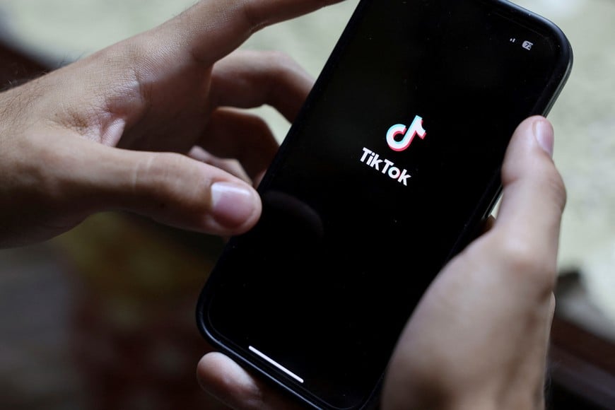An Egyptian man opens the TikTok app, a wave of cases prompting Egypt to consider tighter regulations on social media platforms at his residence in Cairo, Egypt August 20, 2025. REUTERS/Amr Abdallah Dalsh