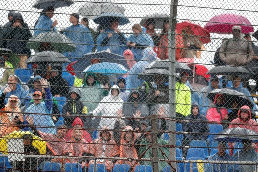 Formula One F1 - Belgian Grand Prix - Spa-Francorchamps, Spa, Belgium - August 29, 2021 Spectators in the rain as the race is delayed due to bad weather REUTERS/Johanna Geron