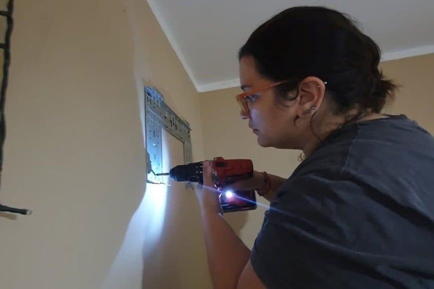 “Mamá Repara”, taladro en mano, haciendo una instalación. Crédito: Gentileza