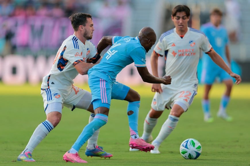 Jul 26, 2025; Fort Lauderdale, Florida, USA; Inter Miami CF midfielder Fafa Picault (14) dribbles the ball against FC Cincinnati midfielder Pavel Bucha (20) during the first half at Chase Stadium. Mandatory Credit: Sam Navarro-Imagn Images