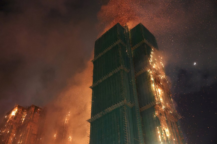 Fire burns bamboo scaffolding across multiple buildings at Wang Fuk Court housing estate, in Tai Po, Hong Kong, China, November 26, 2025. REUTERS/Tyrone Siu