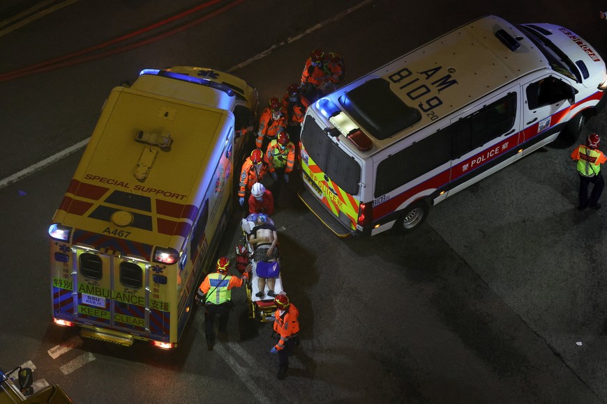 A man receives medical attention, as fire burns bamboo scaffolding across multiple buildings at Wang Fuk Court housing estate, in Tai Po, Hong Kong, China, November 26, 2025. REUTERS/Tyrone Siu