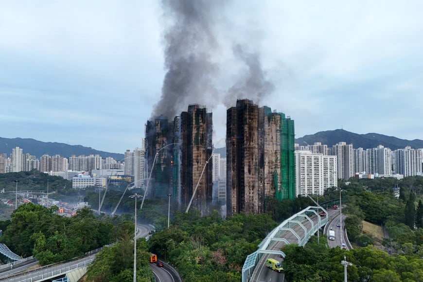 A drone view shows flames and thick smoke rising from the Wang Fuk Court housing estate during a major fire, in Tai Po, Hong Kong, China, November 27, 2025. REUTERS/Tyrone Siu