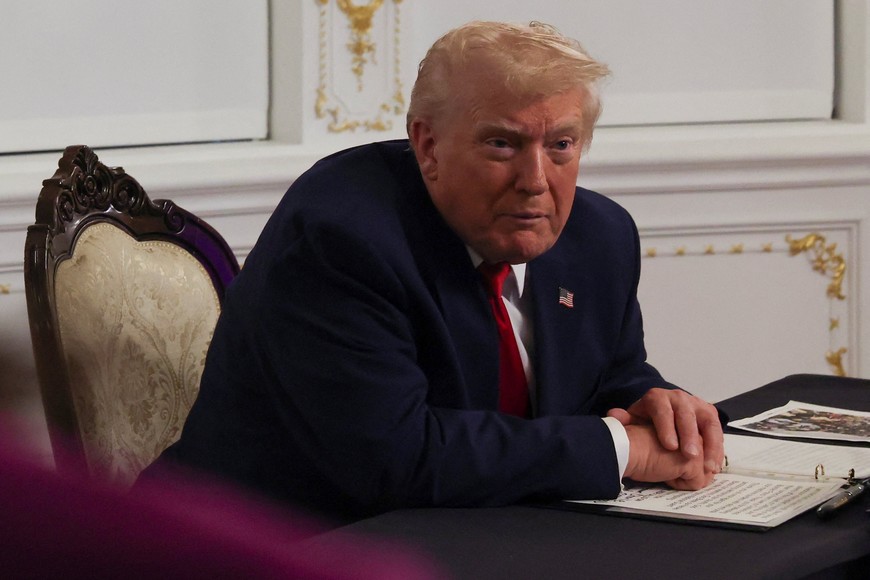 U.S. President Donald Trump speaks with members of the media following a call with military service members, on Thanksgiving, in Palm Beach, Florida, U.S., November 27, 2025. REUTERS/Anna Rose Layden