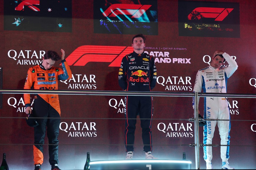 Formula One F1 - Qatar Grand Prix - Lusail International Circuit, Lusail, Qatar - November 30, 2025
Red Bull's Max Verstappen stands on the podium after winning the Qatar Grand Prix alongside second placed McLaren's Oscar Piastri and third placed Williams' Carlos Sainz Jr. REUTERS/Mohammed Salem