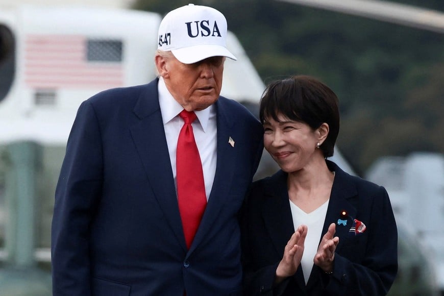 U.S. President Donald Trump walks with Japanese Prime Minister Sanae Takaichi, aboard the aircraft carrier USS George Washington, during a visit to U.S. Navy's Yokosuka base in Yokosuka, Japan, October 28, 2025. REUTERS/Evelyn Hockstein