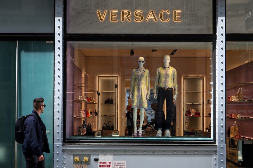 A man walks by a Versace store in New York City, U.S., April 10, 2025. REUTERS/Kylie Cooper