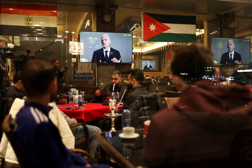 Screens show FIFA President Gianni Infantino as people gather at a cafe to watch the FIFA World Cup 2026 Draw, in Amman, Jordan, December 5, 2025. REUTERS/Alaa Al Sukhni