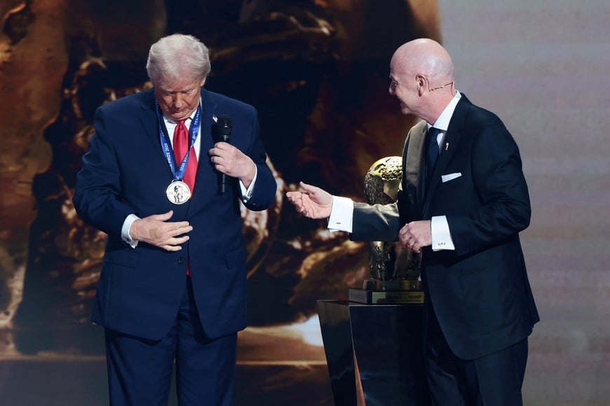 Soccer Football - FIFA World Cup 2026 - FIFA World Cup 2026 Draw - John F. Kennedy Center for the Performing Arts, Washington, D.C., U.S. - December 5, 2025
U.S. President Donald Trump wears a medal as he is awarded the inaugural FIFA Peace Prize by FIFA President Gianni Infantino during the FIFA World Cup 2026 Draw REUTERS/Evelyn Hockstein