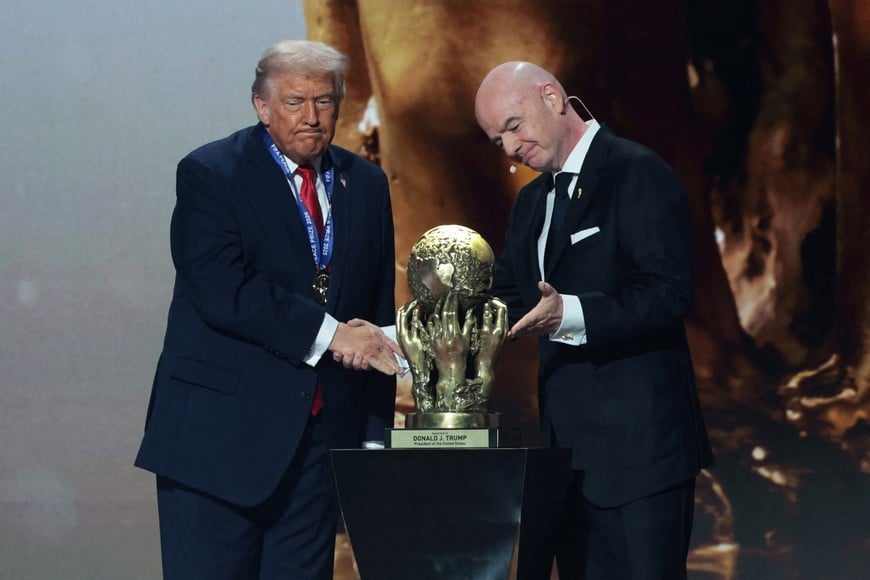 Soccer Football - FIFA World Cup 2026 - FIFA World Cup 2026 Draw - John F. Kennedy Center for the Performing Arts, Washington, D.C., U.S. - December 5, 2025
U.S. President Donald Trump shakes hands with FIFA President Gianni Infantino after being awarded the inaugural FIFA Peace Prize during the FIFA World Cup 2026 Draw REUTERS/Jonathan Ernst