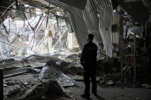 A police officer stands at the site of a terminal of the Nova Poshta (New Post) delivery service damaged during a Russian drone strike, amid Russia's attack on Ukraine, in Odesa, Ukraine May 1, 2025. REUTERS/Nina Liashonok     TPX IMAGES OF THE DAY