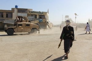 Afghan Taliban fighters patrol near the Afghanistan-Pakistan border in Spin Boldak, Kandahar Province, following exchanges of fire between Pakistani and Afghan forces in Afghanistan, October 15, 2025. REUTERS/Stringer     TPX IMAGES OF THE DAY