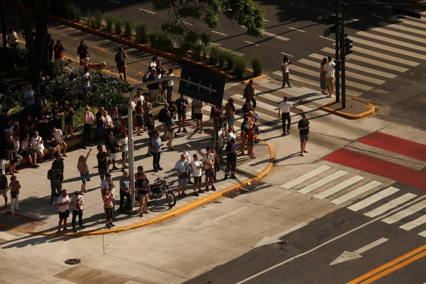 People watch from the streets as Argentine F-16 jets fly over downtown Buenos Aires during their reception ceremony, after being purchased from Denmark, in Buenos Aires, Argentina, December 6, 2025. Reuters/Cristina Sille