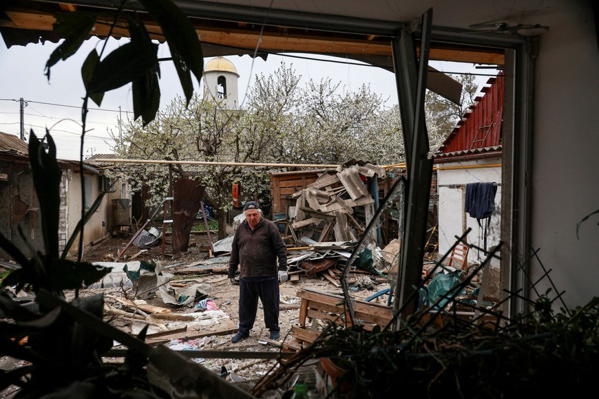 A resident stands on a backyard of his house damaged during a Russian drone strike, amid Russia's attack on Ukraine, in Odesa, Ukraine April 16, 2025. REUTERS/Nina Liashonok     TPX IMAGES OF THE DAY
