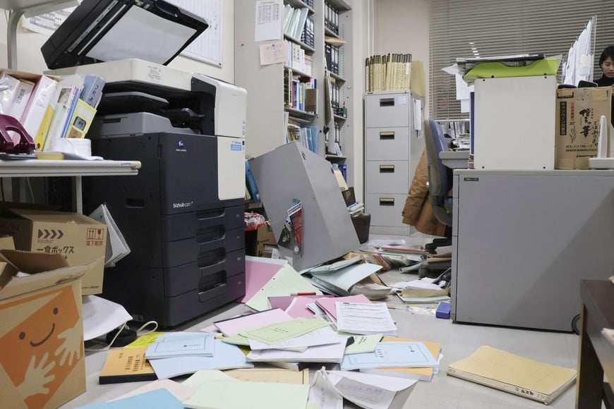Bookshelves and documents that fell during an earthquake are seen at Kyodo News' Hakodate bureau in Hakodate, Hokkaido, Japan, December 8, 2025 in this photo taken by Kyodo. Mandatory credit Kyodo/via REUTERS ATTENTION EDITORS - THIS IMAGE HAS BEEN SUPPLIED BY A THIRD PARTY. MANDATORY CREDIT. JAPAN OUT. NO COMMERCIAL OR EDITORIAL SALES IN JAPAN.