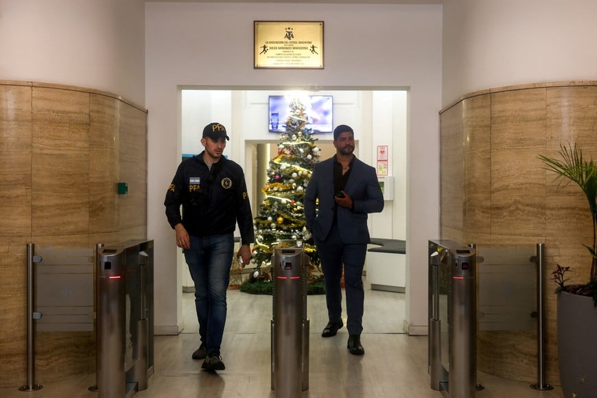 A member of the Argentine Federal Police walks at the entrace of the Argentine Football Association (AFA) headquarters, where Federal Police raid amid investigation into alleged money laundering, according to local media, in Buenos Aires, Argentina December 9, 2025. REUTERS/Cristina Sille