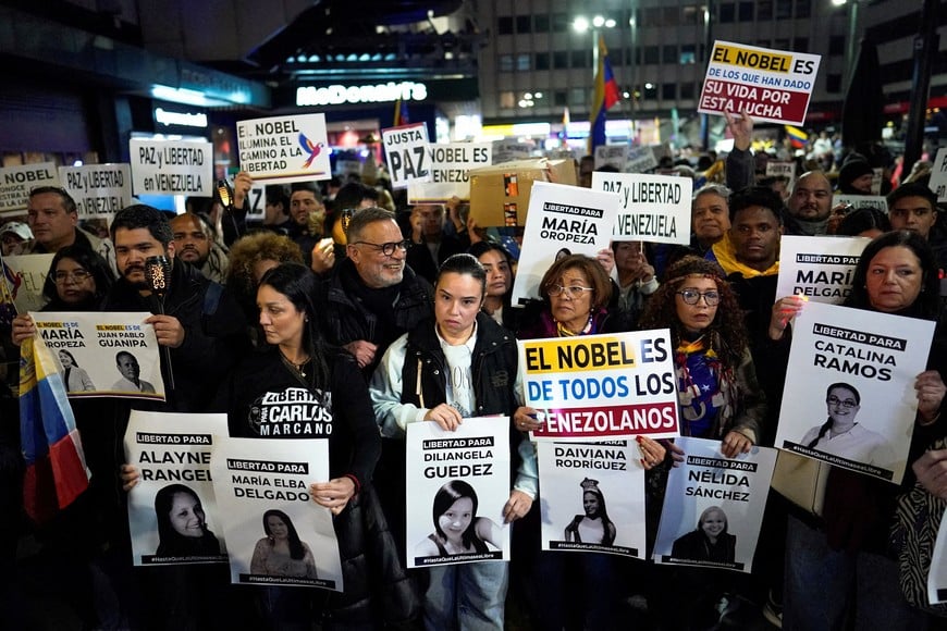 Family members of people imprisoned under the government of Venezuelan President Nicolas Maduro hold placards with their images, as Venezuelans living in Spain gather for a global march in support of Nobel Peace Prize winner Maria Corina Machado, in Madrid, Spain, December 6, 2025. REUTERS/Ana Beltran
     TPX IMAGES OF THE DAY