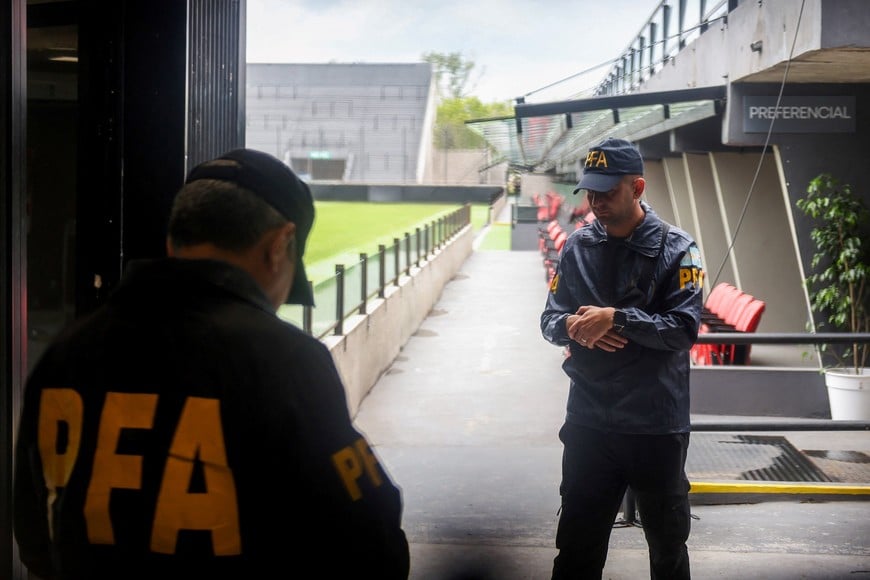 Members of the Argentine Federal Police walk inside the Claudio Chiqui Tapia stadium, which belongs to the soccer team Barracas Central, where Federal Police raid amid investigation into alleged money laundering, according to local media, in Buenos Aires, Argentina December 9, 2025. REUTERS/Cristina Sille