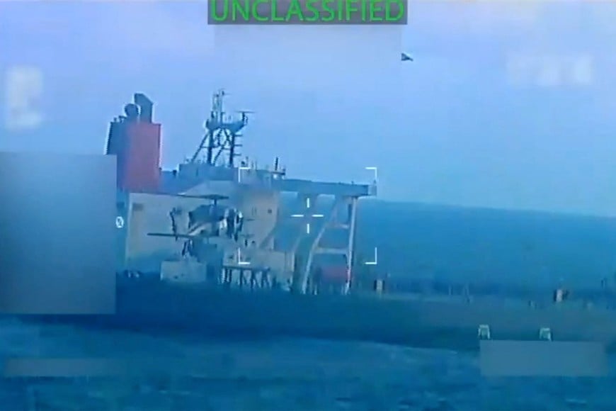 A U.S. military helicopter flies near an oil tanker during a raid described by U.S. Attorney General Pam Bondi as its seizure by the United States off the coast of Venezuela, December 10, 2025, in a still image from video.  U.S. Attorney General/Handout via REUTERS. THIS IMAGE HAS BEEN SUPPLIED BY A THIRD PARTY. SELECTIVE BLURRING FROM SOURCE.