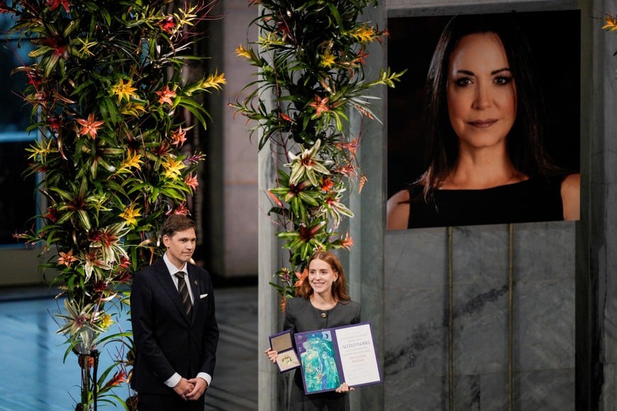 Ana Corina Sosa Machado, daughter of Nobel Peace Prize laureate Maria Corina Machado, accepts the award on behalf of her mother, during the Nobel Peace Prize award ceremony at Oslo City Hall, in Oslo, Norway December 10, 2025. Stian Lysberg Solum/NTB/via REUTERS ATTENTION EDITORS - THIS IMAGE WAS PROVIDED BY A THIRD PARTY. NORWAY OUT. NO COMMERCIAL OR EDITORIAL SALES IN NORWAY.