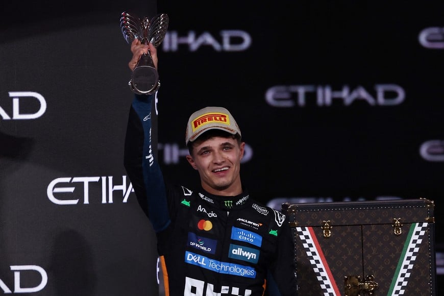 Formula One F1 - Abu Dhabi Grand Prix - Yas Marina Circuit, Abu Dhabi, United Arab Emirates - December 7, 2025
McLaren's Lando Norris celebrates on the podium with the trophy after becoming the 2025 Formula One World Champion REUTERS/Amr Alfiky