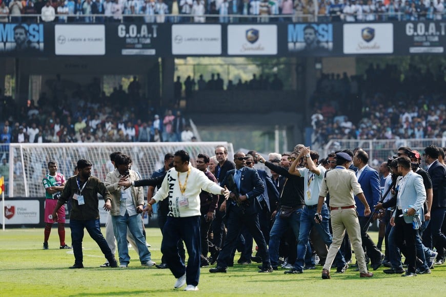 Soccer Football - Argentine soccer star Lionel Messi on a whirlwind tour of India - Vivekananda Yuva Bharati Krirangan, Kolkata, India - December 13, 2025
Argentine soccer star Lionel Messi walks on the pitch, surrounded by security during his tour of India REUTERS/Sahiba Chawdhary