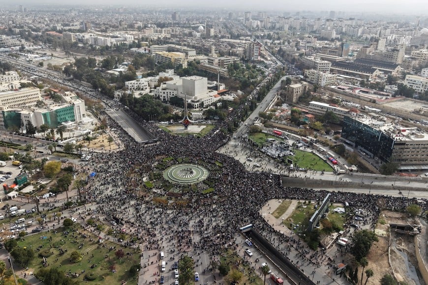 A drone view shows people gathering on the day of a military parade, as Syrians mark the first anniversary of Bashar al-Assad's fall, in Damascus, Syria December 8, 2025. REUTERS/Khalil Ashawi
