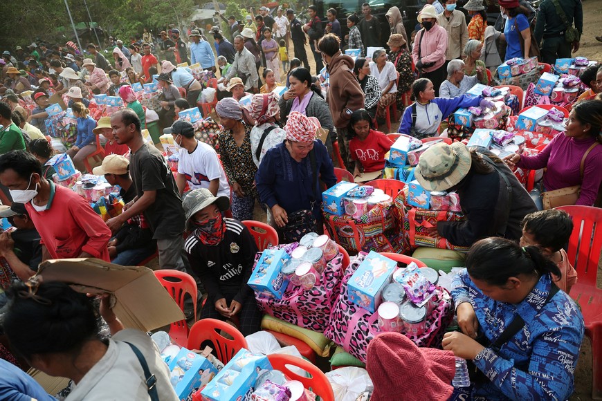 People sit next to supplies after evacuation at Batthkav refugee camp, amid clashes between Thailand and Cambodia along a disputed border area, in Chong Kal, Oddar Meanchey Province, Cambodia, December 12, 2025.    REUTERS/Kim Hong-Ji