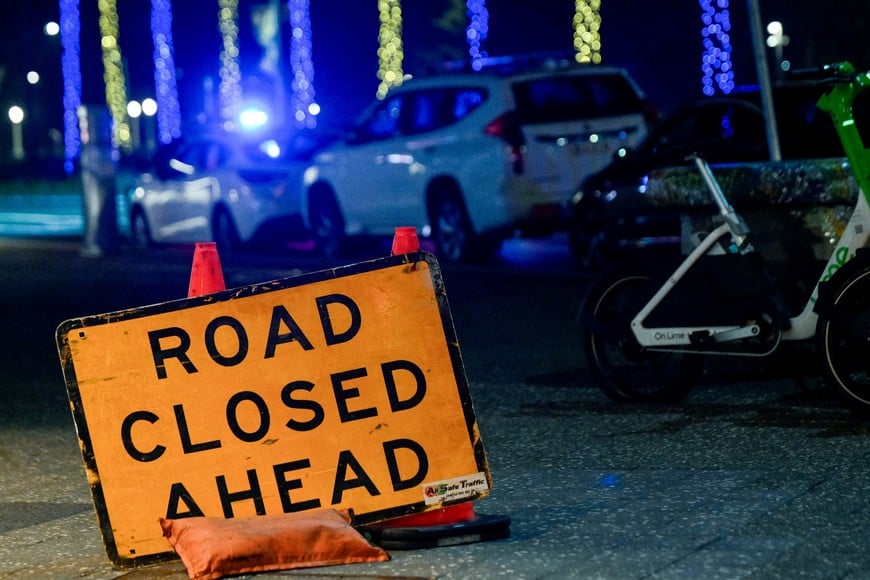 A sign at the scene of a shooting incident at Bondi Beach, Sydney, Australia, December 14, 2025. REUTERS/Izhar Khan