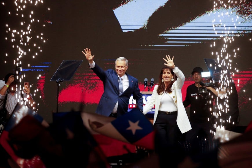 Jose Antonio Kast, presidential candidate of the far-right Republican Party of Chile and his wife Maria Pia Adriasola wave to their supporters as they celebrate after Kast won Chile's presidency in a presidential runoff election, in Santiago, Chile, December 14, 2025. REUTERS/Rodrigo Garrido