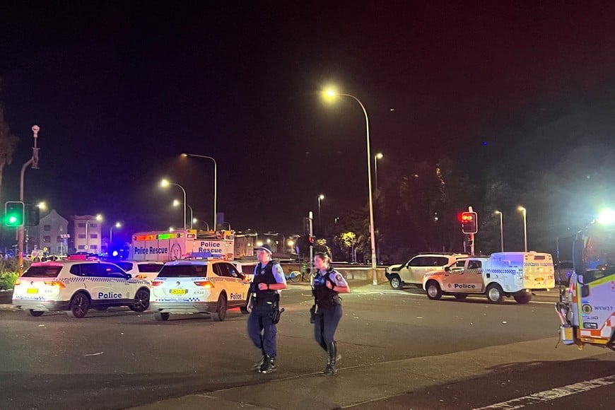 Police officers walk at the scene of a shooting incident at Bondi Beach, Sydney, Australia, December 14, 2025. REUTERS/Kirsty Needham